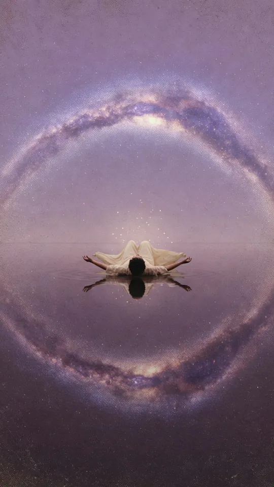 A traveller floats on still water inside a ring of stars and the Milky Way.